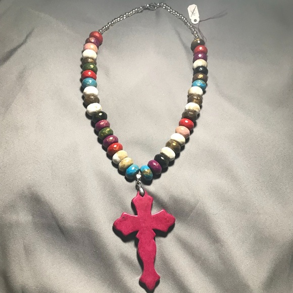 cross necklace with one colored bead